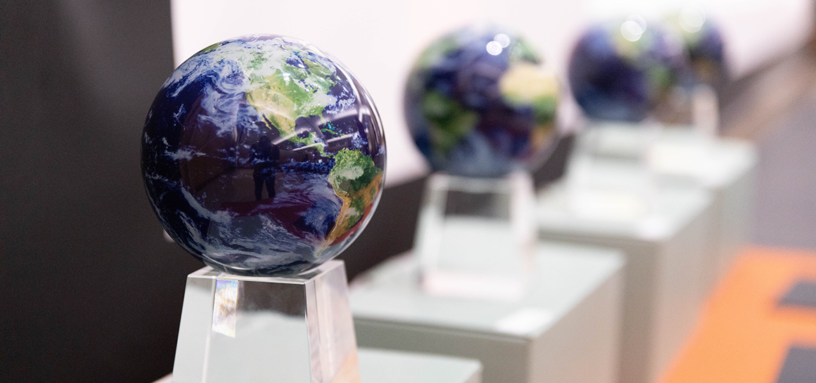 Photo of glass globes of Earth on stands